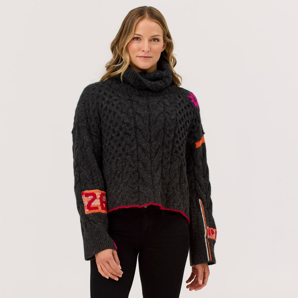 Black Freebird Turtleneck: hand-appliqued baby alpaca–merino with rich cables and embroidery
